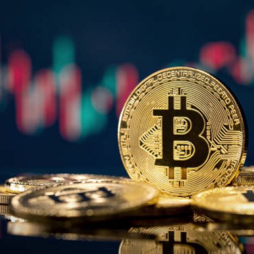 Golden bitcoin coin over defocused stock chart with copy space, Olsztyn, Poland 13 July 2021