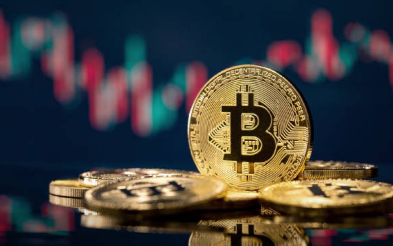 Golden bitcoin coin over defocused stock chart with copy space, Olsztyn, Poland 13 July 2021